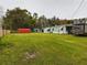 Large backyard with mobile home, RV, and red shed at 5490 Morgan Rd, Lakeland, FL 33810