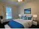 Main bedroom with plush bedding and calming decor at 5490 Morgan Rd, Lakeland, FL 33810