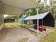 Carport with covered parking and lawn tractor at 5490 Morgan Rd, Lakeland, FL 33810