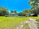 Single-wide manufactured home with covered porch and large yard at 5490 Morgan Rd, Lakeland, FL 33810