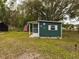 Small green guest house with screened porch and American flag at 5490 Morgan Rd, Lakeland, FL 33810