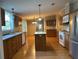 Kitchen with wood cabinets, island, and stainless steel appliances at 5490 Morgan Rd, Lakeland, FL 33810