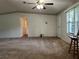 Open living room with carpeted floors and neutral walls at 5490 Morgan Rd, Lakeland, FL 33810