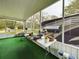 Screened porch with folding table and chairs, artificial turf at 5490 Morgan Rd, Lakeland, FL 33810
