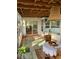 Cozy screened porch with table and chairs at 34 Pine Rd, Babson Park, FL 33827