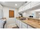 Bright kitchen with white cabinets, tan countertops, and modern appliances at 2070/2071 Corner Lake Dr # 2, Haines City, FL 33844