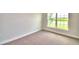 Bright bedroom with carpeted floors and large window at 4024 Tullamore Ln, Auburndale, FL 33823