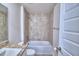 Bathroom with tub, shower, granite vanity, and tile surround at 4024 Tullamore Ln, Auburndale, FL 33823