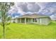 House exterior and grassy backyard at 4024 Tullamore Ln, Auburndale, FL 33823