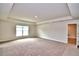Spacious main bedroom with carpeted floor and large window at 4024 Tullamore Ln, Auburndale, FL 33823