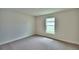 Bright bedroom with neutral carpeting and large window at 4024 Tullamore Ln, Auburndale, FL 33823
