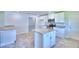 Island kitchen with white cabinets, granite countertops, and stainless steel appliances at 4024 Tullamore Ln, Auburndale, FL 33823