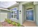 House entrance with blue door and landscaping at 4024 Tullamore Ln, Auburndale, FL 33823