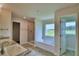 Main bathroom with soaking tub, shower, and double vanity at 4024 Tullamore Ln, Auburndale, FL 33823