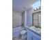 Bathroom with tub, shower, granite vanity, and tile surround at 4024 Tullamore Ln, Auburndale, FL 33823