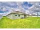 House exterior and grassy backyard at 4024 Tullamore Ln, Auburndale, FL 33823