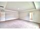 Spacious main bedroom with carpeted floor and large window at 4024 Tullamore Ln, Auburndale, FL 33823