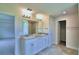Main bathroom with double vanity and access to other rooms at 4024 Tullamore Ln, Auburndale, FL 33823