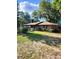 Brick ranch house with a spacious lawn and mature trees at 4450 Old Berkley Rd, Auburndale, FL 33823