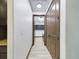 Long hallway with light walls and dark brown doors at 547 S Hankin Rd, Bartow, FL 33830