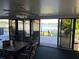 Sunroom with water view and sliding doors at 103 Lake Thomas Dr, Winter Haven, FL 33880