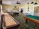 Relaxing game room with shuffleboard and billiard tables at 17 Edinburgh Dr, Haines City, FL 33844