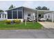 Single-wide manufactured home with carport and golf cart at 17 Edinburgh Dr, Haines City, FL 33844