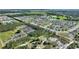 Bird's-eye view of a suburban neighborhood with houses, trees, and open areas at 856 Sun Burst Rd, Winter Haven, FL 33880
