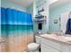 Clean bathroom with beach-themed decor and a shower/tub combo at 856 Sun Burst Rd, Winter Haven, FL 33880