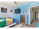 Blue bedroom with a bed, dresser, and doorway to another room at 856 Sun Burst Rd, Winter Haven, FL 33880