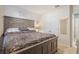 Cozy bedroom featuring a large, rustic-style bed and double closet doors at 856 Sun Burst Rd, Winter Haven, FL 33880