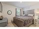 Inviting bedroom with king-size bed, rustic decor, and large windows at 856 Sun Burst Rd, Winter Haven, FL 33880