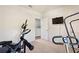 Home gym with exercise equipment, a TV, and a doorway at 856 Sun Burst Rd, Winter Haven, FL 33880