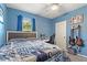 Blue bedroom with a bed, desk, chair, and wall-mounted guitars at 856 Sun Burst Rd, Winter Haven, FL 33880