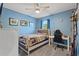 Blue bedroom featuring a bed, desk, chair, and ceiling fan at 856 Sun Burst Rd, Winter Haven, FL 33880