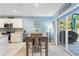 Dining area adjacent to the kitchen, featuring a wooden table and sliding glass doors at 856 Sun Burst Rd, Winter Haven, FL 33880