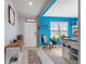 Welcoming entryway with blue walls, a white door, and a small sitting area at 856 Sun Burst Rd, Winter Haven, FL 33880