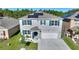 Two-story home with solar panels, blue shutters, and a two-car garage at 856 Sun Burst Rd, Winter Haven, FL 33880