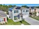 Two-story home with solar panels, a landscaped yard, and a welcoming front porch at 856 Sun Burst Rd, Winter Haven, FL 33880