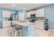 Modern kitchen with white cabinets, stainless steel appliances, and an island with bar seating at 856 Sun Burst Rd, Winter Haven, FL 33880