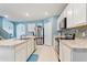 Bright kitchen with white cabinets, a stainless steel refrigerator, and an island cooktop at 856 Sun Burst Rd, Winter Haven, FL 33880