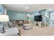 Living room with a large sectional, an entertainment center, and stairs leading to the second floor at 856 Sun Burst Rd, Winter Haven, FL 33880