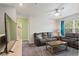 Cozy living area with two reclining sofas, wooden coffee table, and large TV at 856 Sun Burst Rd, Winter Haven, FL 33880