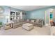 Cozy living room with a sectional sofa, a coffee table, and blue walls at 856 Sun Burst Rd, Winter Haven, FL 33880