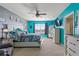 Large main bedroom with a king-size bed, teal accent wall, and ceiling fan at 856 Sun Burst Rd, Winter Haven, FL 33880