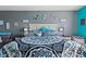 King-size bed, stylish bedding, and unique wall art in the main bedroom at 856 Sun Burst Rd, Winter Haven, FL 33880