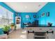 Home office with bold blue walls, ample workspace, and built-in shelving at 856 Sun Burst Rd, Winter Haven, FL 33880