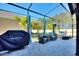 Screened patio with seating and a barbecue grill at 856 Sun Burst Rd, Winter Haven, FL 33880