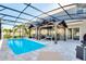 Spacious pool with screened enclosure, wooden cabana, and sitting area at 856 Sun Burst Rd, Winter Haven, FL 33880