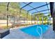 Screened-in pool with a trampoline and lush green backyard at 856 Sun Burst Rd, Winter Haven, FL 33880